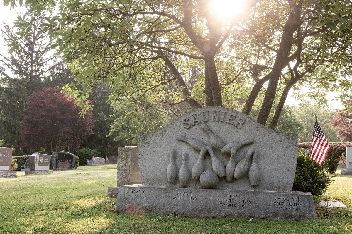 Sculpted headstone with sports carvings