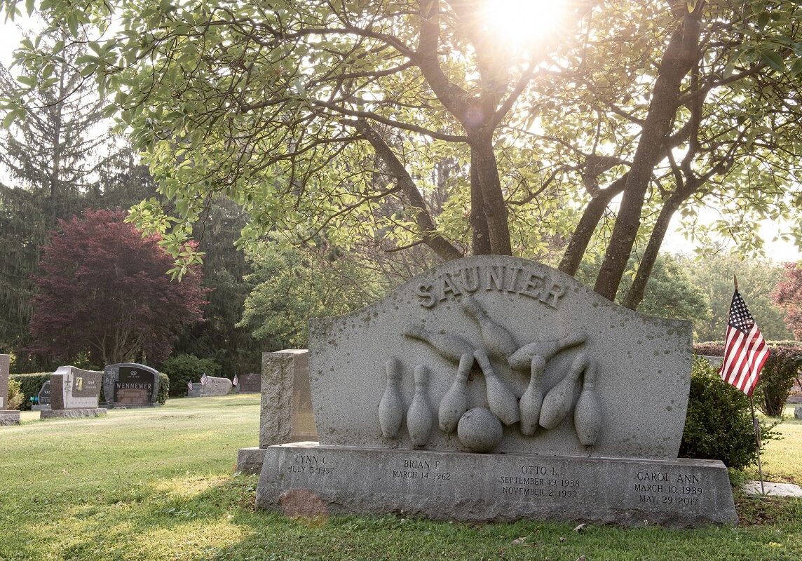 Sculpted headstone with sports carvings