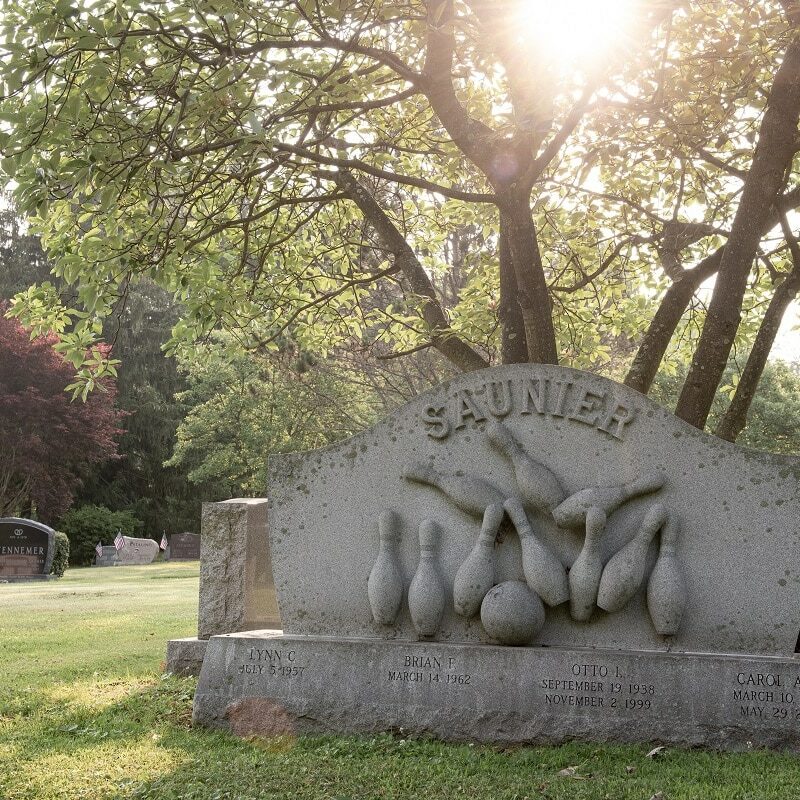 Sculpted headstone with sports carvings