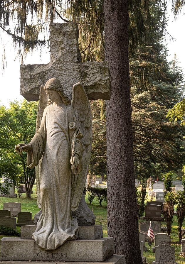 Sculpted headstone of a cross with an angel with open arms - Custom Memorial