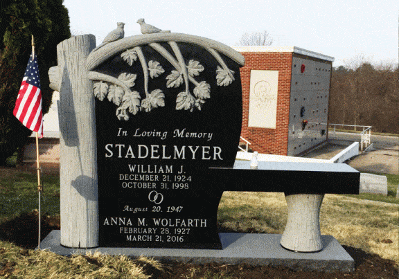 Headstone monument with bench